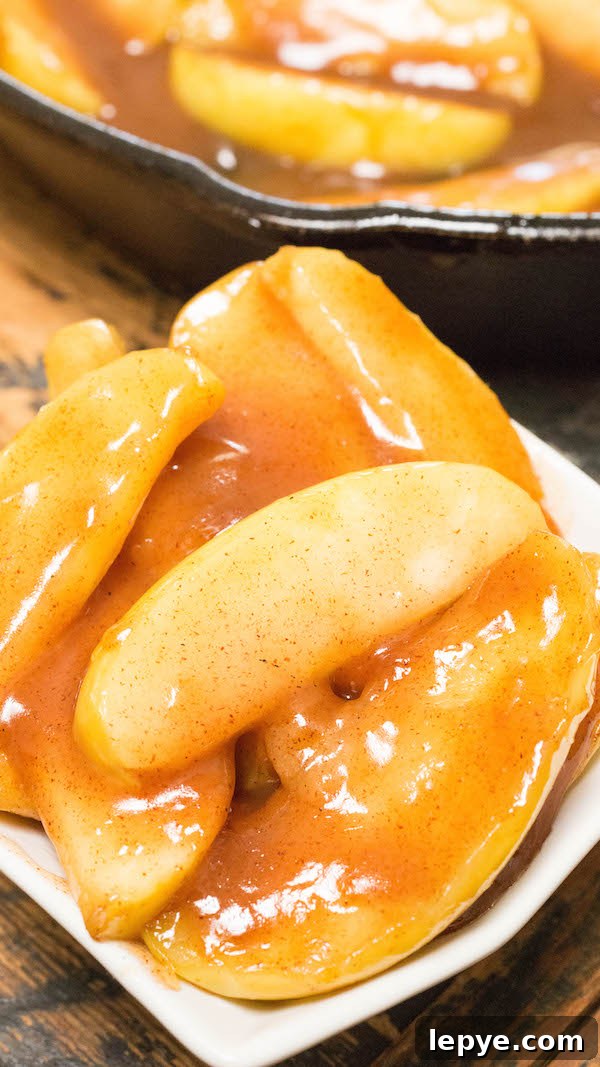 Cracker Barrel–Style Southern Fried Apples Recipe 4 Close up of homemade Cracker Barrel Fried Apples in a white serving dish.