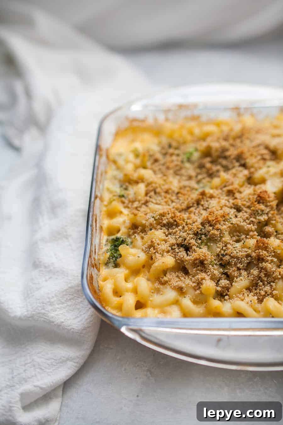 Homemade macaroni and cheese baked in a glass dish.