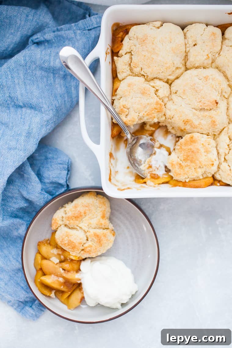 Square baking dish with peach cobbler.