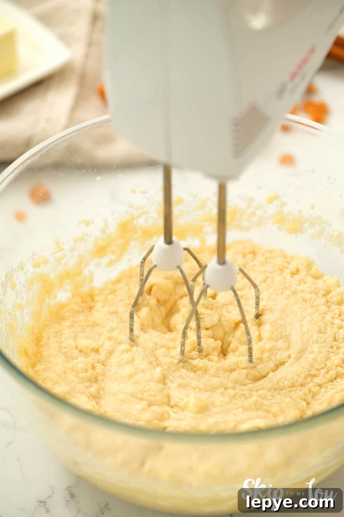Chewy Toffee Doodle Cookie Recipe for Perfect Crunch and Flavor 4 Batter for Toffee Doodle Cookies mixed with a hand mixer in a large clear mixing bowl. -Skip To My Lou