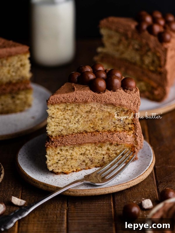 Slices of moist banana cake on ceramic dessert plates on a dark wood background.
