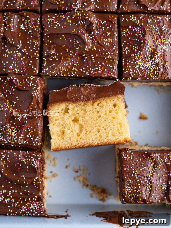 Slices of 4 egg yellow sheet cake in blue baking tin.