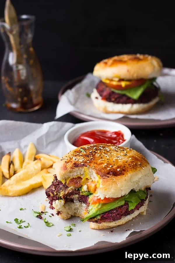 A quinoa beet burger with a bite taken out.