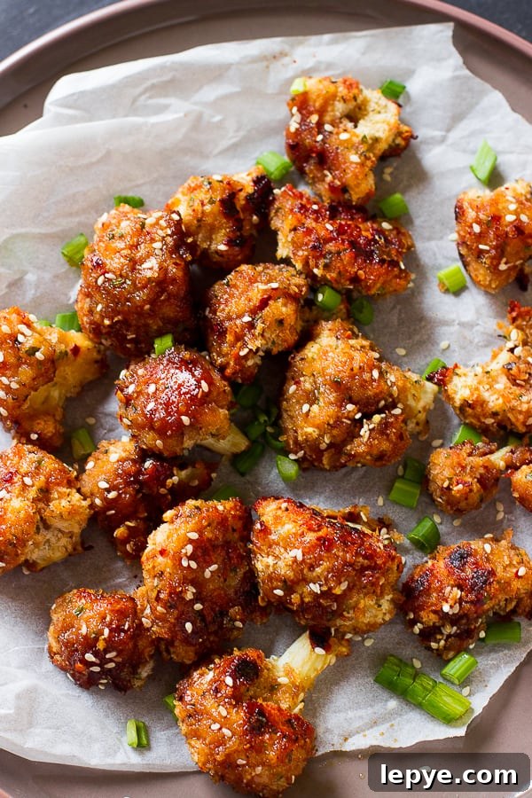 Overhead shot of sticky cauliflower wings on parchment.