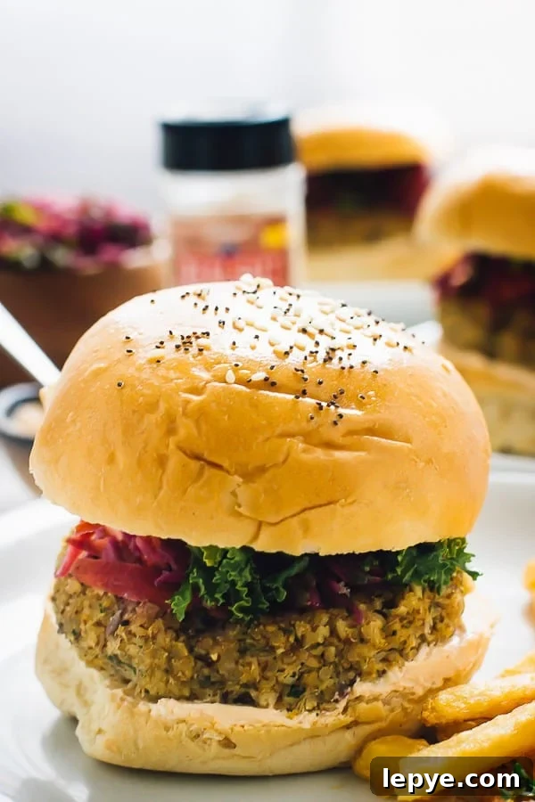 Side shot of quinoa cauliflower burger with fries on the side.