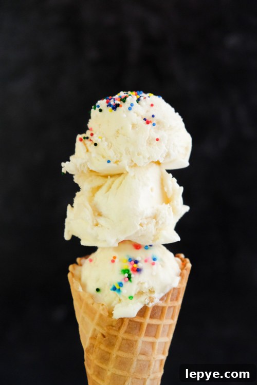 Clotted cream scoops on to of cone