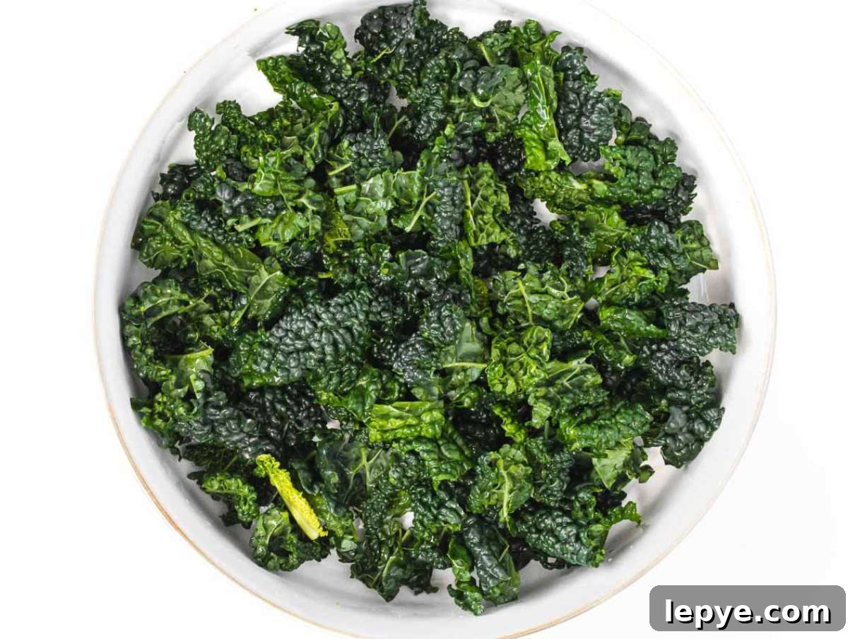 Roasted Butternut Squash and Kale Salad with Quinoa and Cranberries 6 Step 2 Kale leaves chopped and massaged with lemon juice and salt in a large bowl.