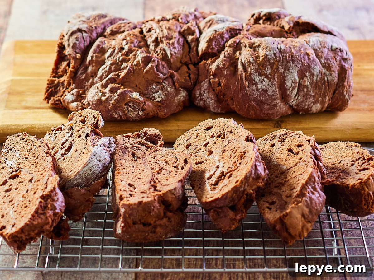 Classic Chocolate Babka Recipe: Swirled Yeast Bread Tutorial 2 Front view of slices of chocolate bobca bread sitting in front of the loaf - Hostess At Heart
