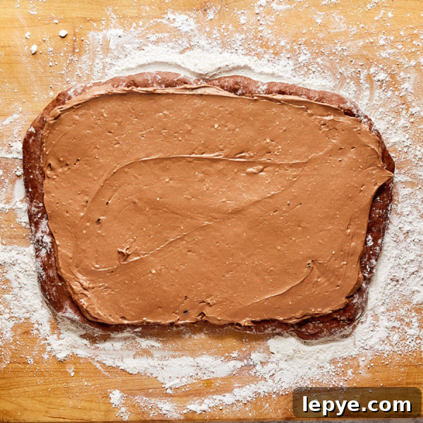 Classic Chocolate Babka Recipe: Swirled Yeast Bread Tutorial 8 Chocolate filling spread over rolled chocolate bread dough - Hostess At Heart