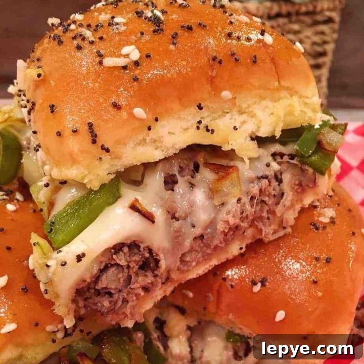 Cheesesteak Sliders stacked on a checkered paper