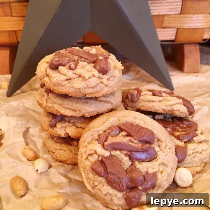 Reese's Peanut Butter Cup Cookies in a stack with peanut surrounding them.