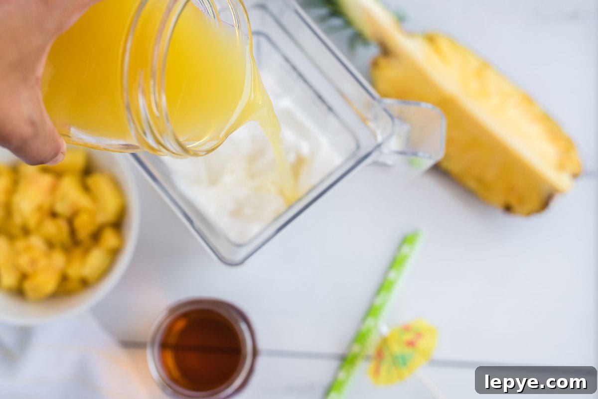 adding pineapple juice to blender