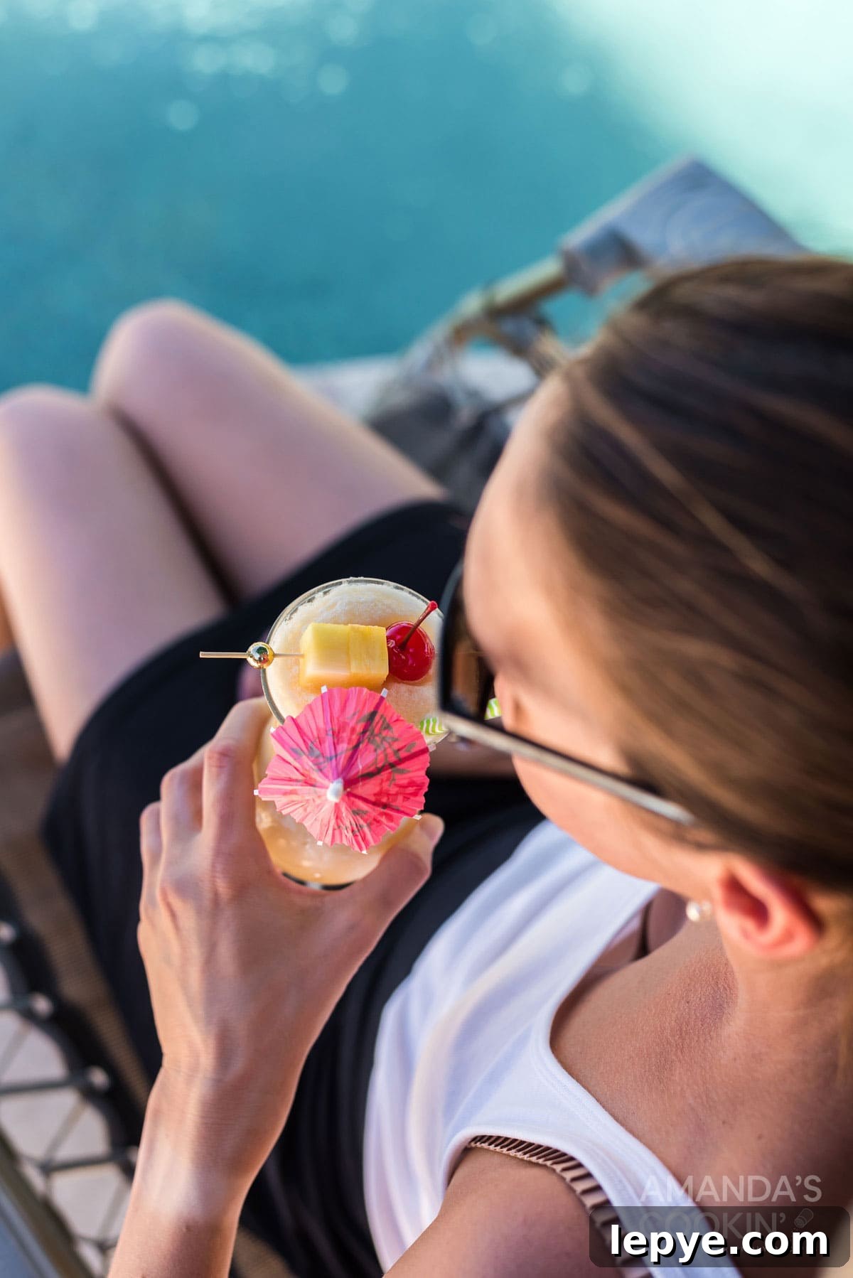 woman sipping on pina colada