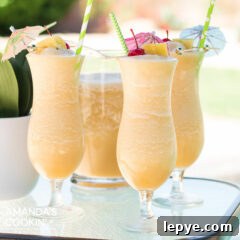 3 pina colada cocktails on a table by the pool
