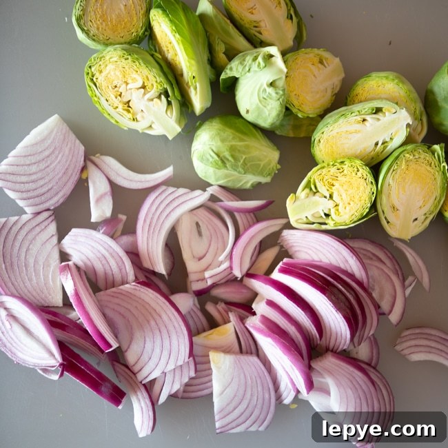 Pan-Roasted Brussels Sprouts with Crispy Eggs and Garlic 3 Raw Brussels sprouts sliced in half and thinly sliced red onions.