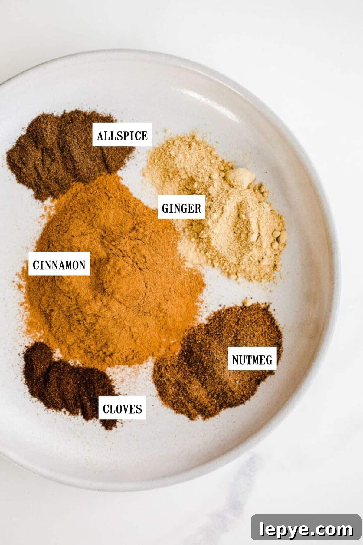 Homemade Pumpkin Pie Spice Blend for Baking and Drinks 3 Spices on a plate.