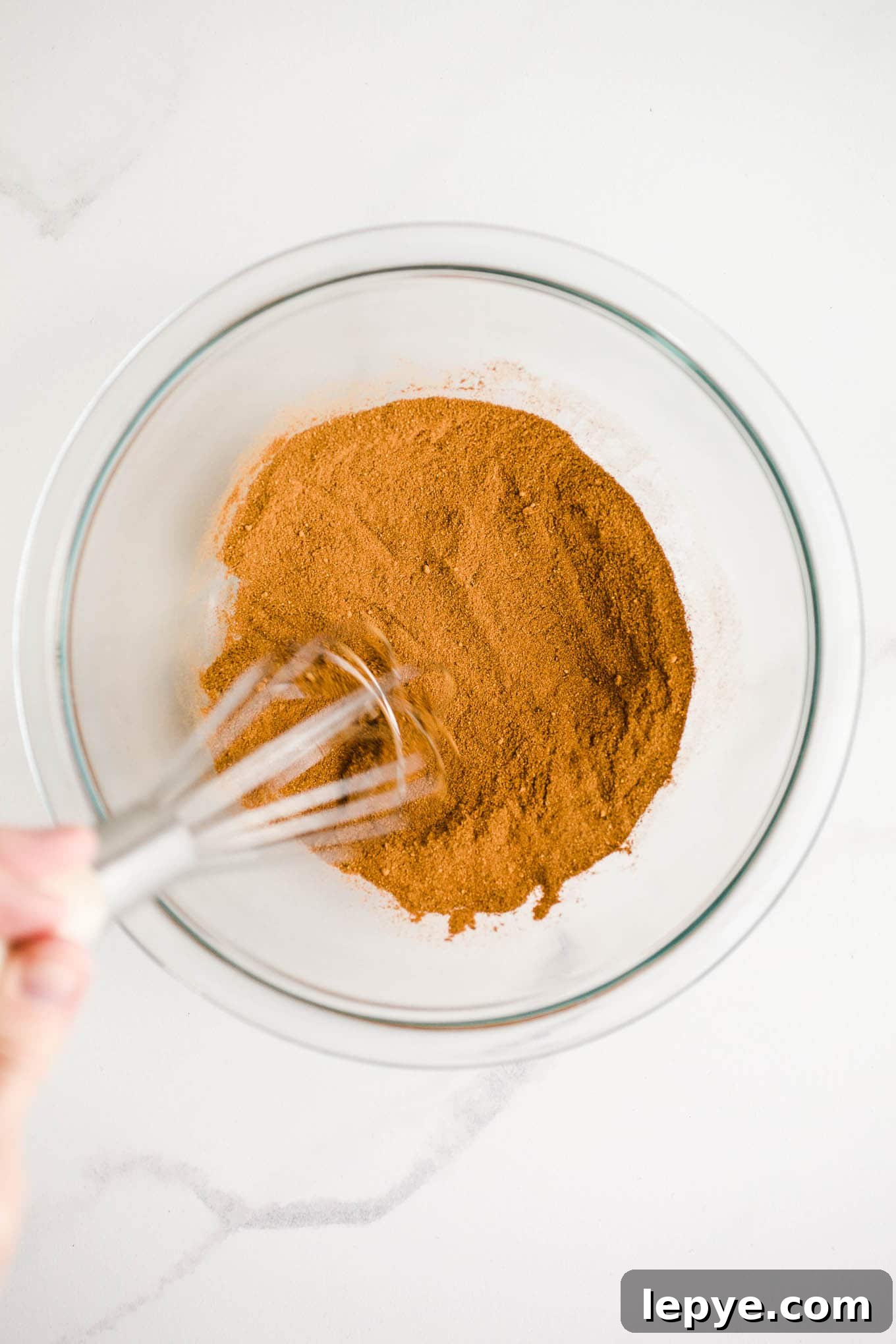 Homemade Pumpkin Pie Spice Blend for Baking and Drinks 4 Spices being whisked in a bowl.