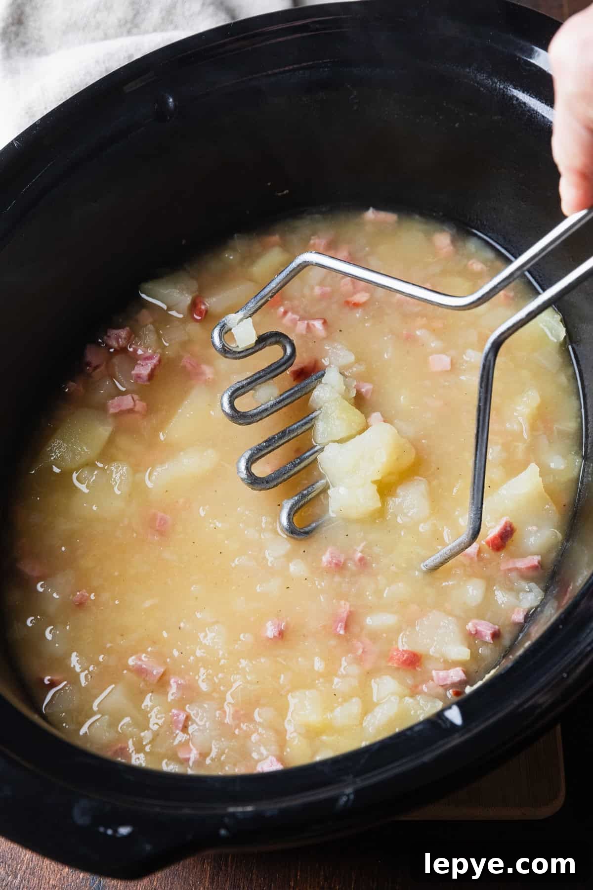 Crockpot Potato Soup with Evaporated Milk — Creamy Dinner Recipe 6 Using a potato masher to make a chunky soup.