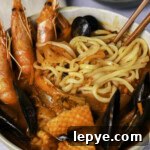 Jjamppong with noodles, shrimps, squid, and mussels.