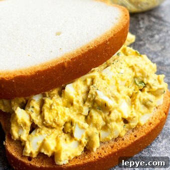 One-Pan Classic Egg Salad Sandwich Recipe 3 Easy Egg Salad Sandwich on Rustic Gray Background
