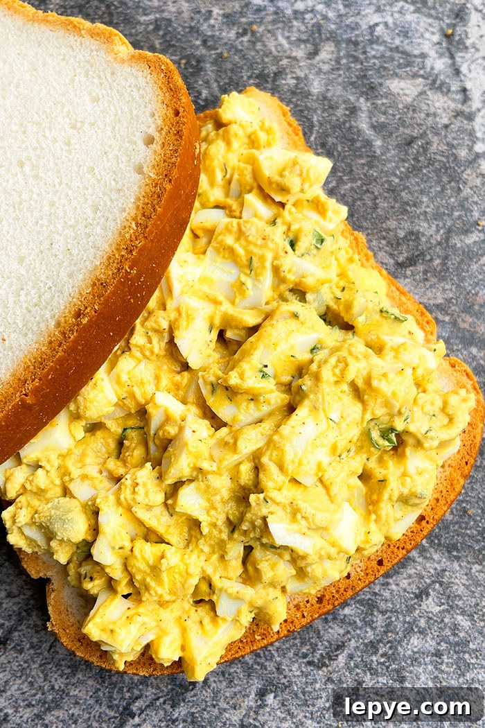 One-Pan Classic Egg Salad Sandwich Recipe 4 Best Sandwich With Creamy Egg Salad on Rustic Gray Background- Overhead Shot