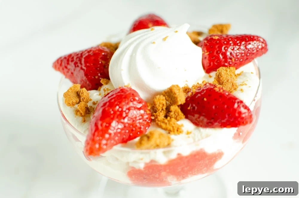 Crushed biscuit placed on top of the cream in a glass to create our Eton mess dessert