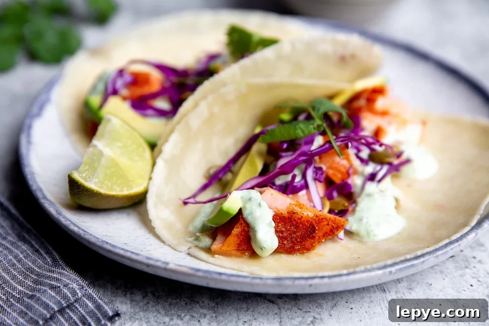 Close up of the yogurt sauce drizzled over salmon tacos. 
