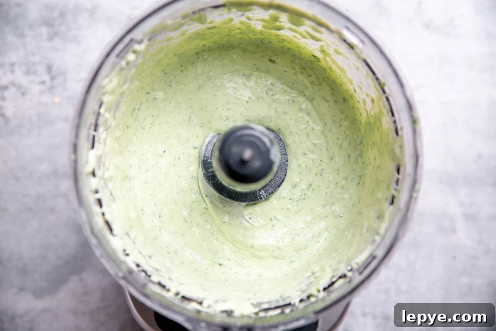 Cilantro lime yogurt sauce in a food processor. 