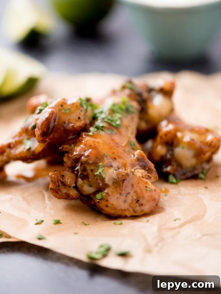 Citrus Tequila-Lime Chicken Wings Recipe for Game Day 2 Tequila lime chicken wings laying on parchment paper.