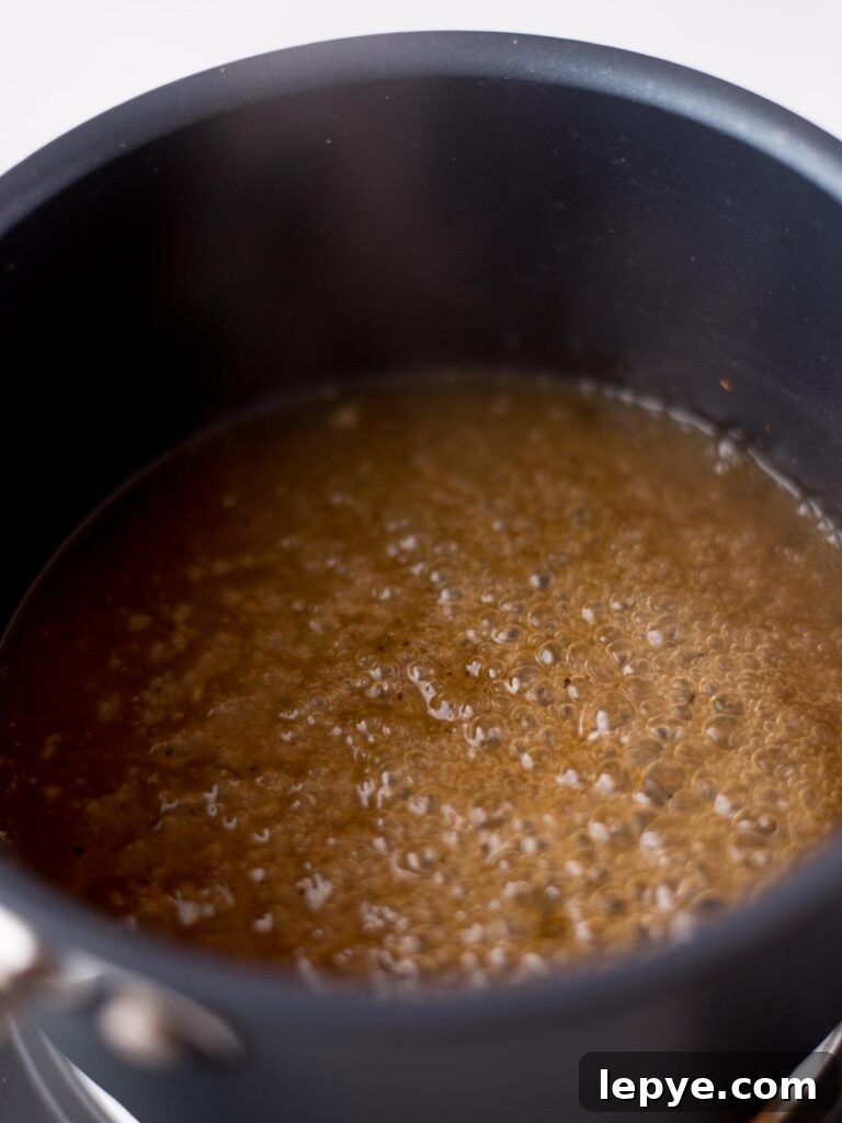 Citrus Tequila-Lime Chicken Wings Recipe for Game Day 8 Tequila glaze simmering in a saucepan.
