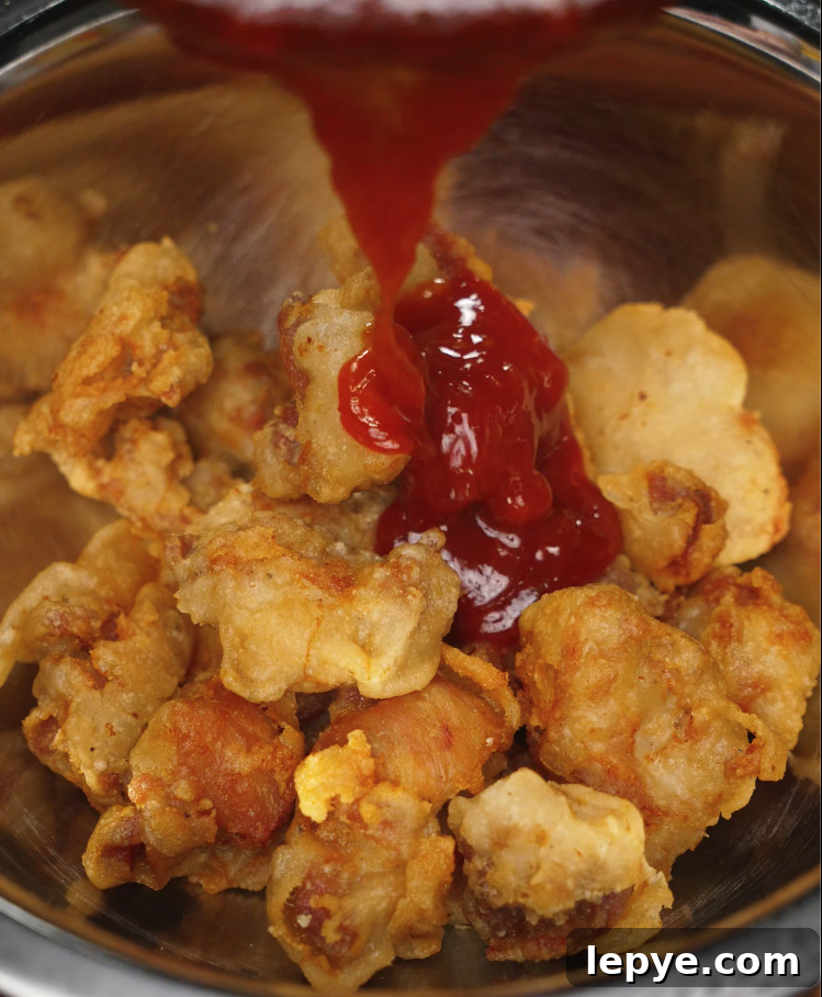 adding-korean-chicken-sauce-to-fried-chicken.jpg