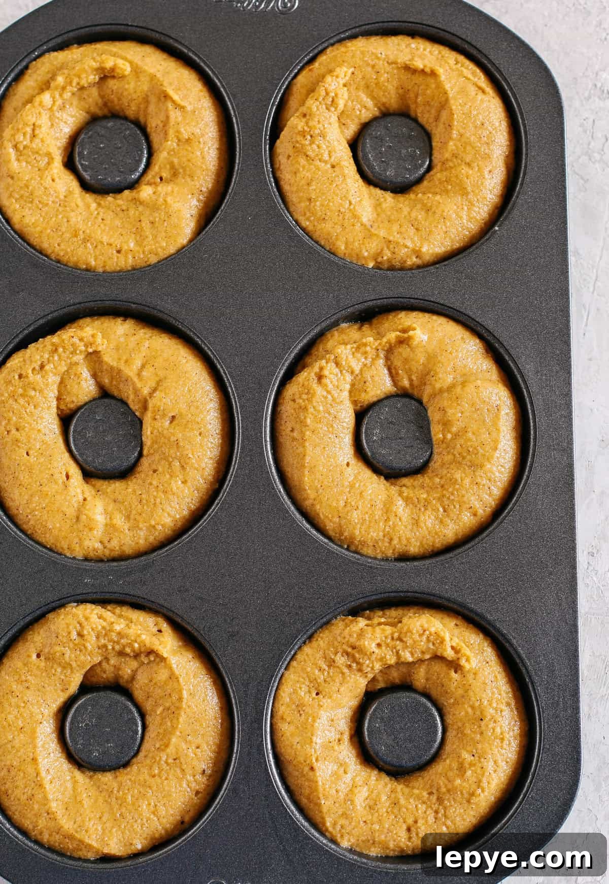 Gluten-Free Pumpkin Spice Donuts Recipe with Crispy Glaze 3 Gluten-Free Pumpkin Spice Donuts coated in cinnamon sugar