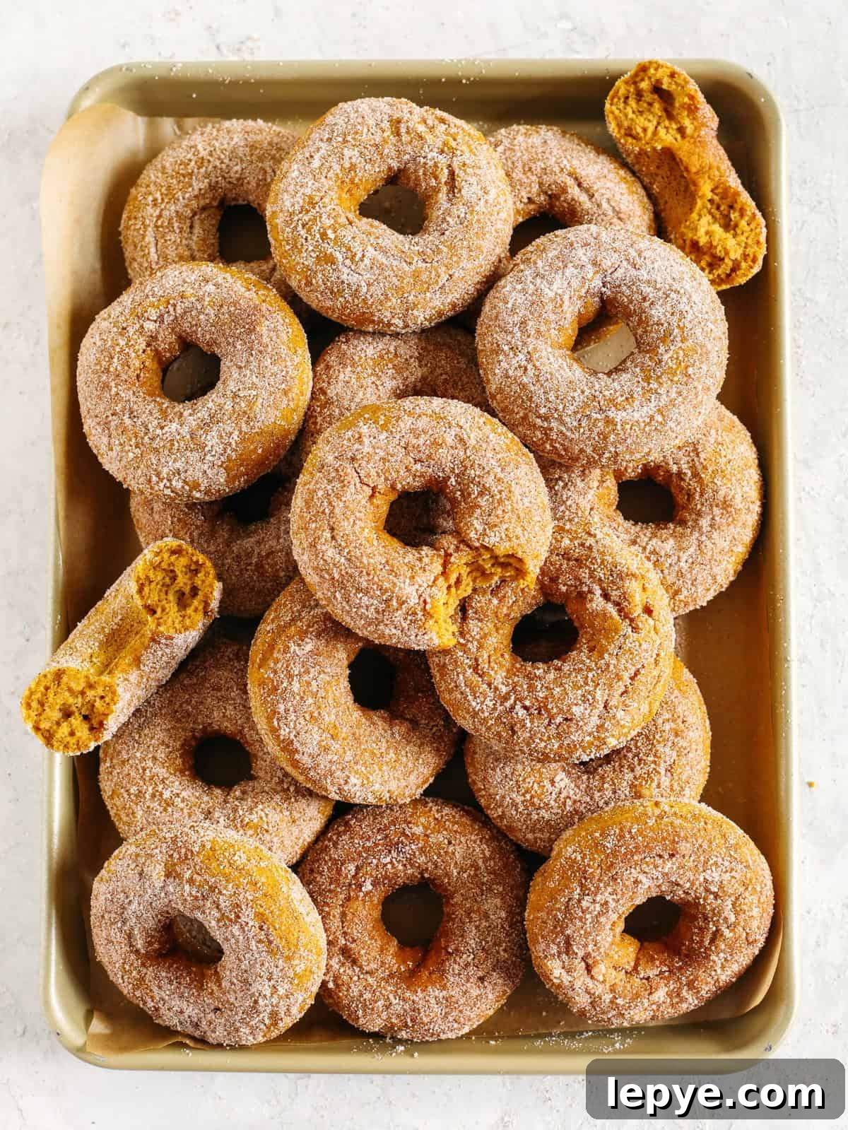 Gluten-Free Pumpkin Spice Donuts Recipe with Crispy Glaze 5 Plate of pumpkin spice donuts with cinnamon sugar