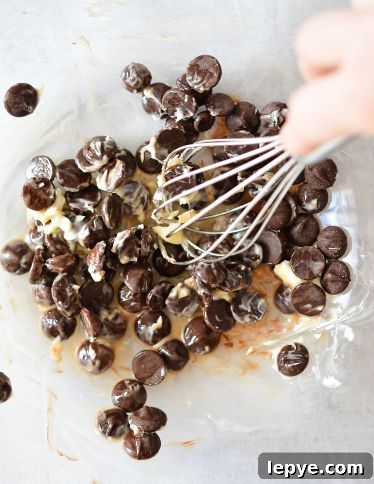 Decadent Chocolate Mousse Recipe for Silky, No-Bake Perfection 7 whisking slightly melted chocolate chips and butter.