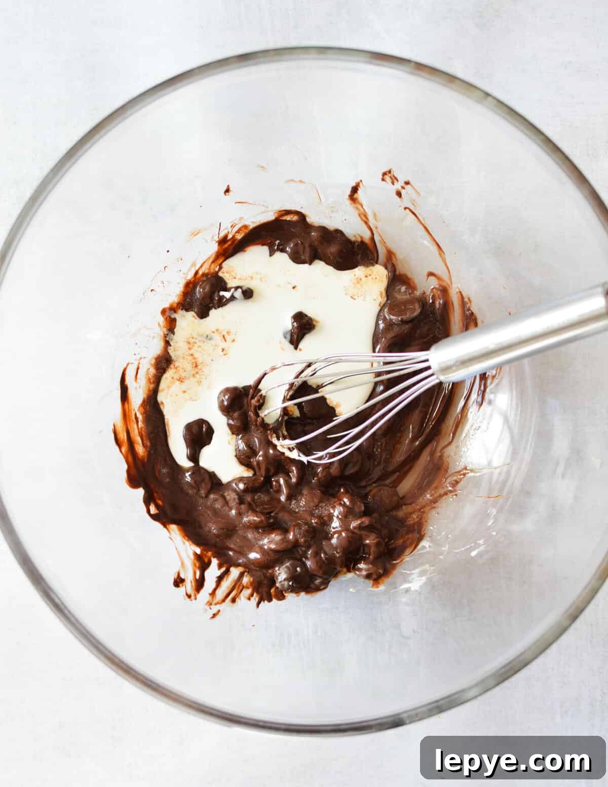 Decadent Chocolate Mousse Recipe for Silky, No-Bake Perfection 8 a bowl of melted chocolate and cream.
