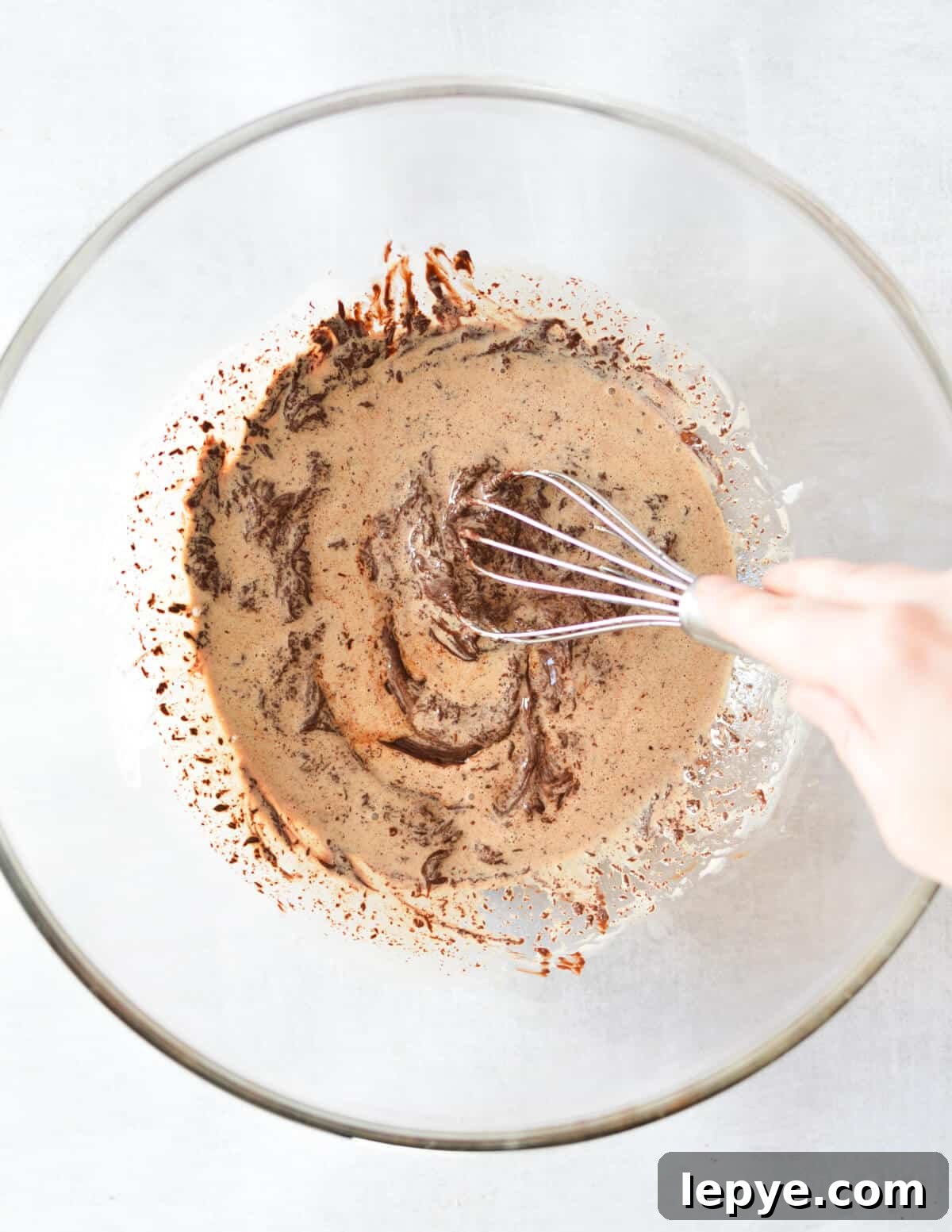Decadent Chocolate Mousse Recipe for Silky, No-Bake Perfection 9 stirring chocolate and cream together.