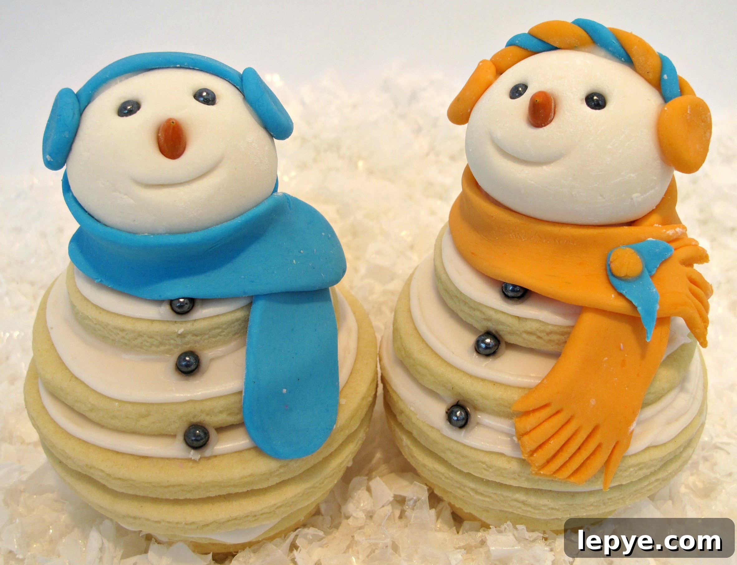 Closeup of two sugar cookie snowmen.