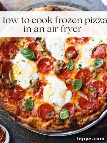 A cooked pizza topped with fresh basil, pepperoni slices and cheese.