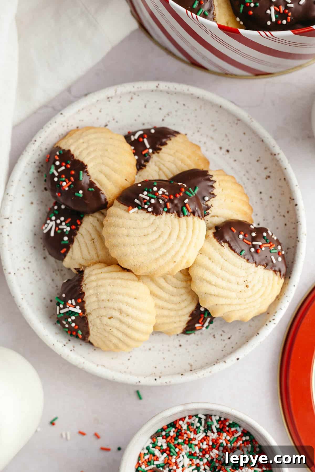 Danish Butter Cookies Dipped in Rich Chocolate 11 Danish piped butter cookies dipped in chocolate on a small plate.