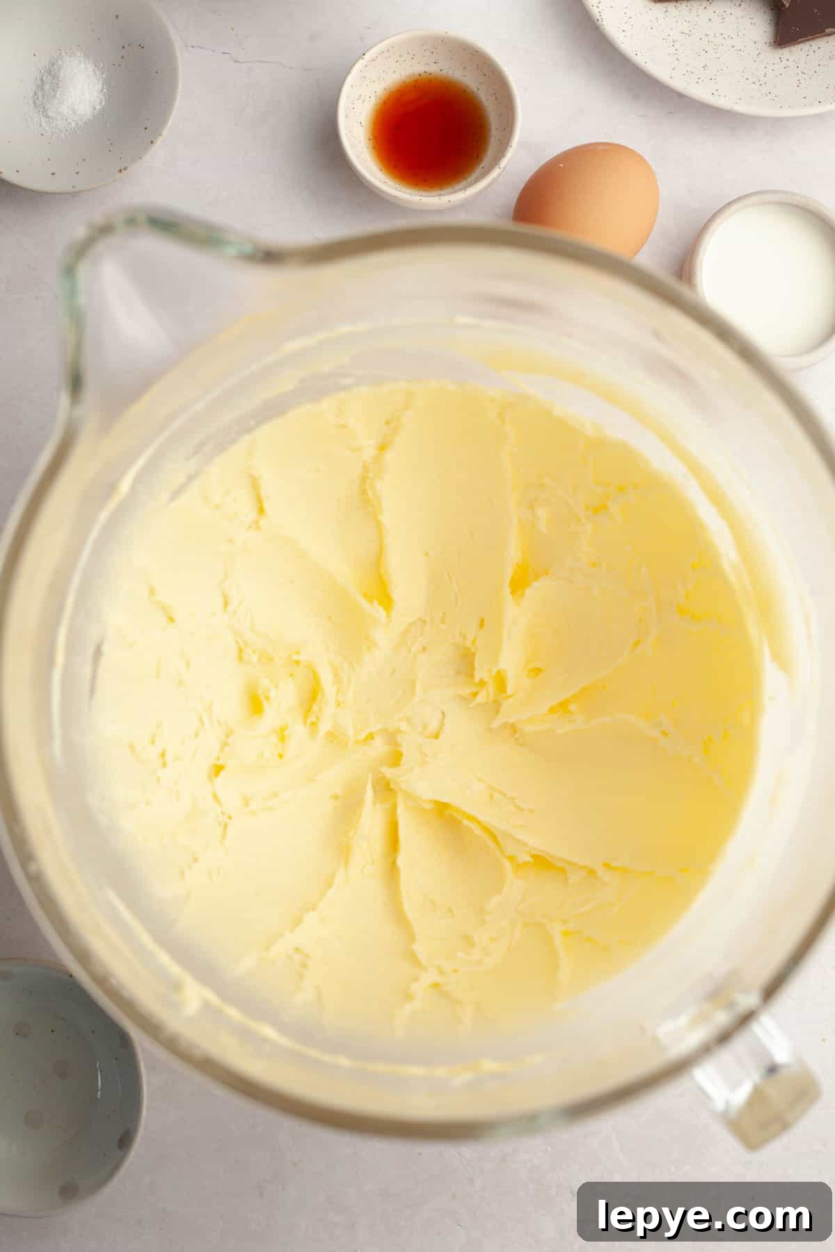 Danish Butter Cookies Dipped in Rich Chocolate 4 A large glass mixing bowl with creamed butter and sugar.