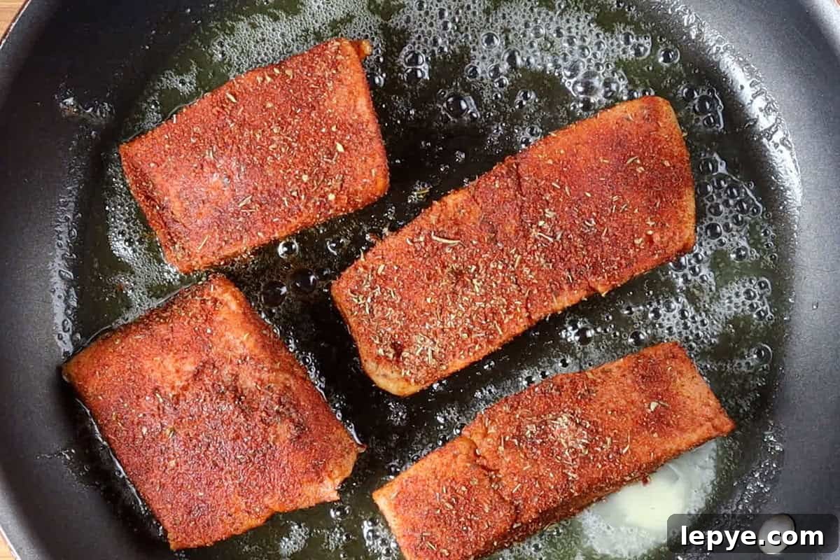 Grilled Salmon with Fresh Mango Salsa Recipe 9 seasoned salmon filets in non stick pan.
