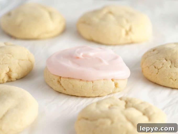 Cream Cheese Frosting Recipe for Cookies: Smooth & Spreadable 11 sugar cookies topped with pink cream cheese frosting for cookies