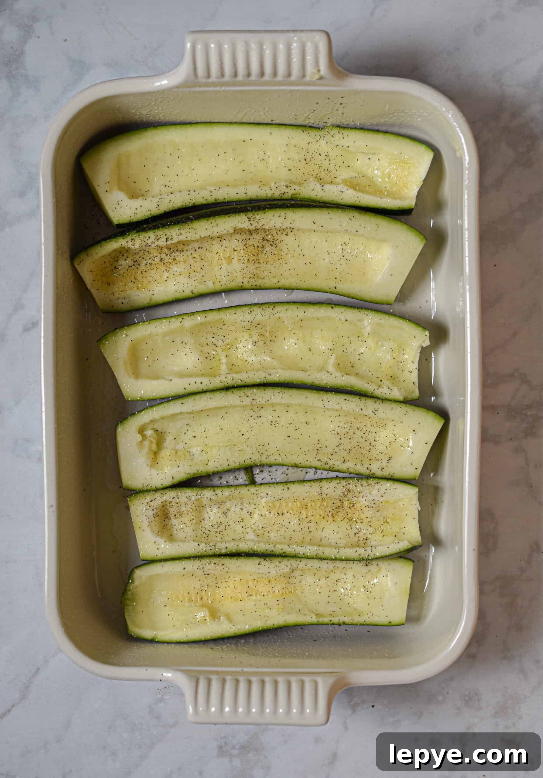 Hollow out the zucchini, keeping the meat aside to chop