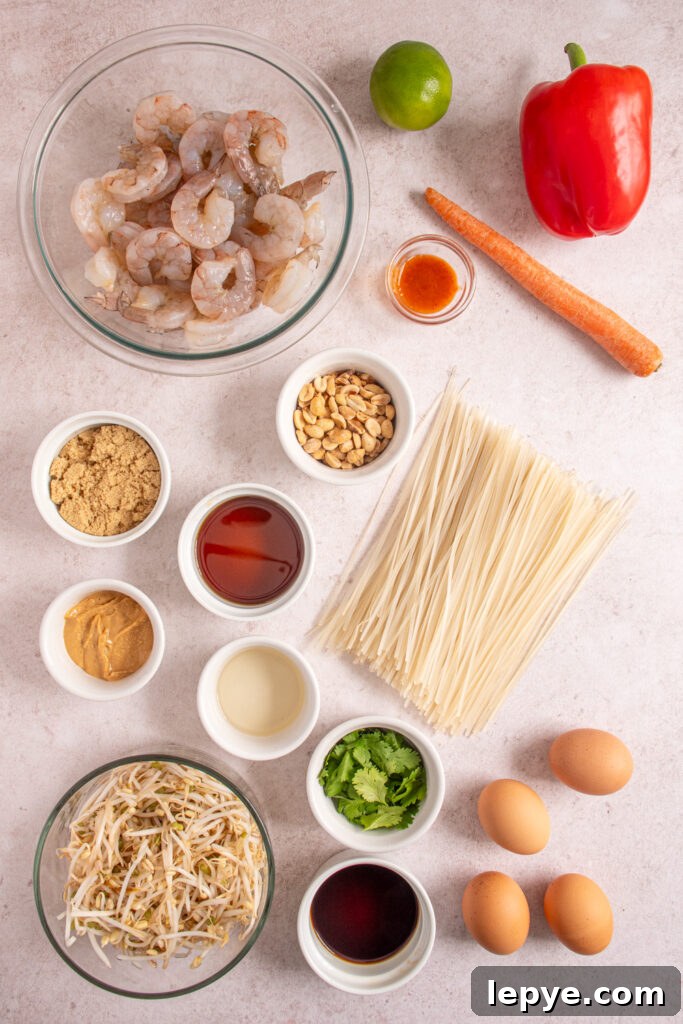Ingredients for making shrimp pad thai laid out on a tabletop.