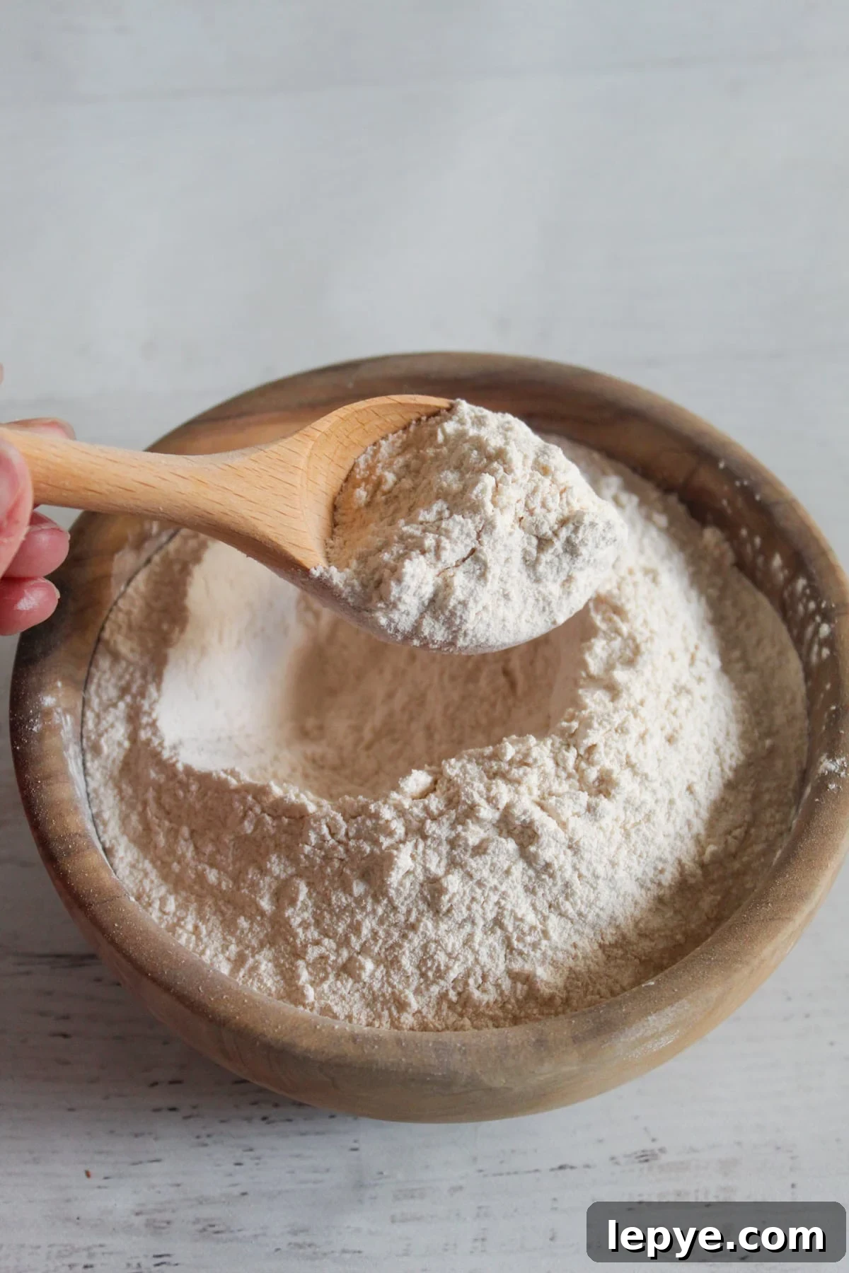 bowl of cassava flour with a wooden spoon