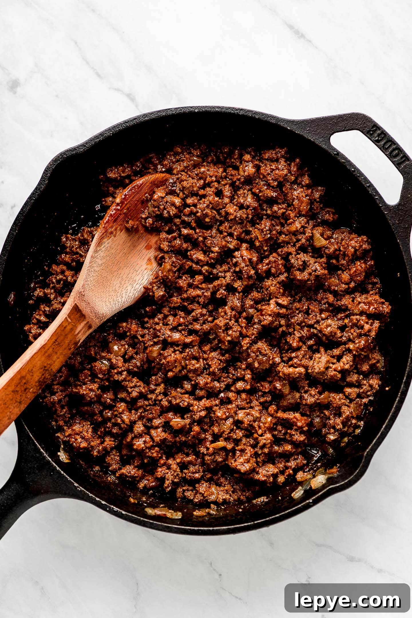 Dorito Taco Salad Recipe: Crunchy Tex-Mex Dinner Idea 9 Ground taco meat in a cast iron skillet.