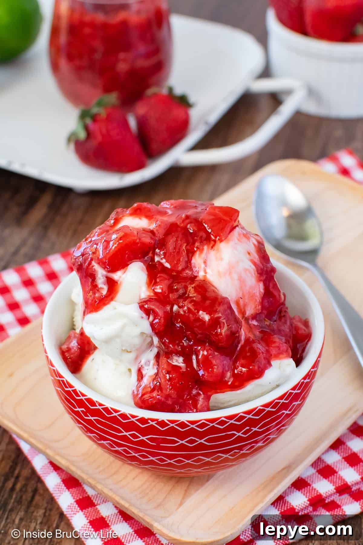 Homemade Strawberry Sauce Recipe for Desserts & Pancakes 5 A bowl of vanilla ice cream topped with a honey strawberry sauce.