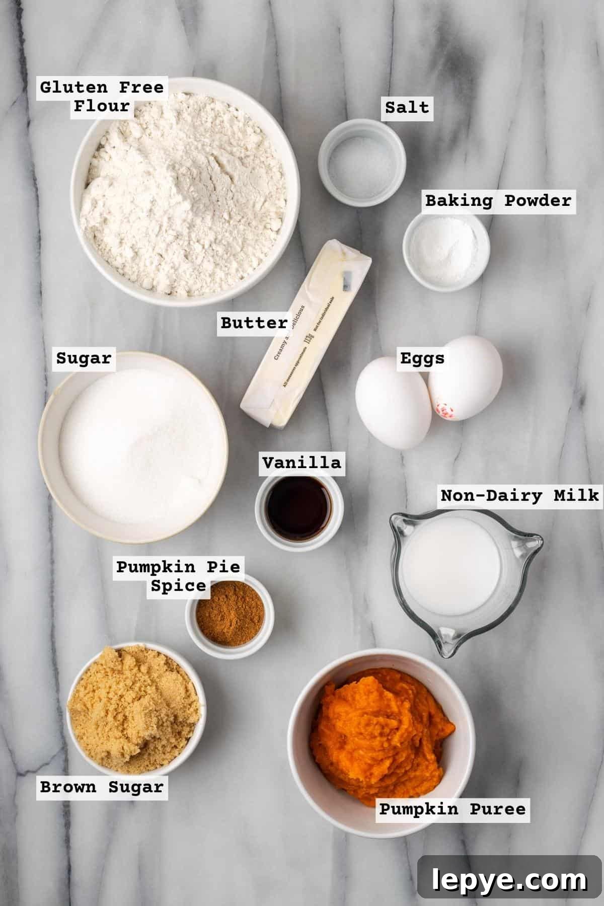 Ingredients for pumpkin coffee cake on a white marble table.