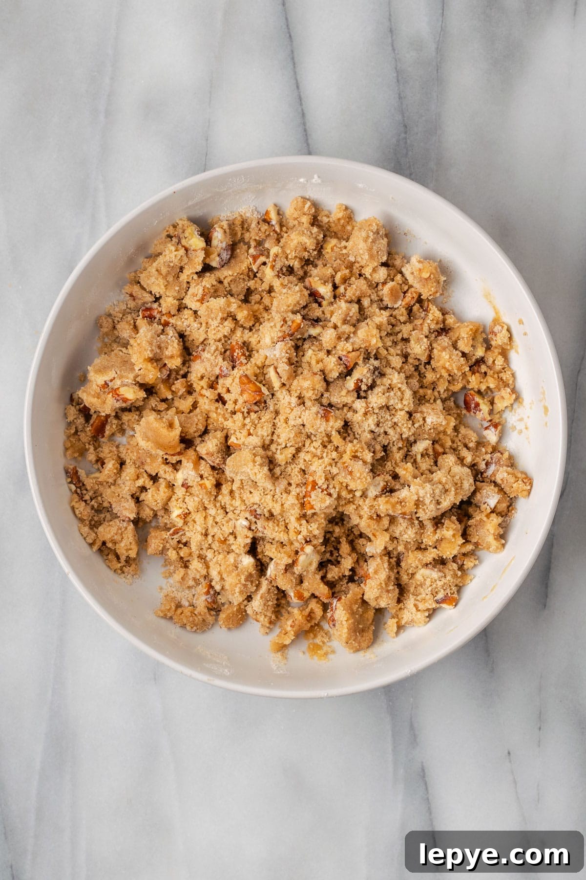 Crumb topping for the pumpkin coffee cake in a white bowl.