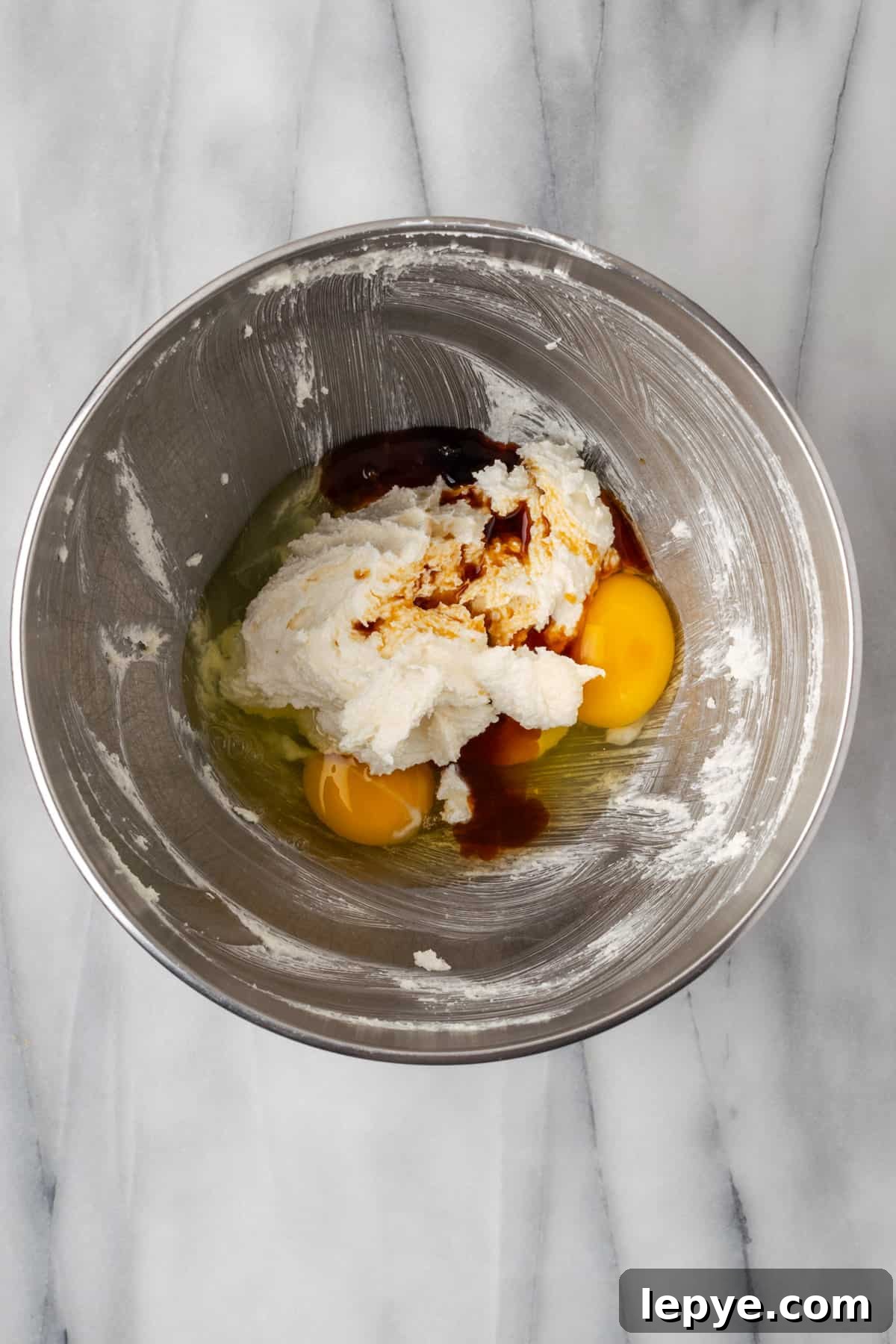 Eggs and vanilla added to the creamed butter and sugar mixture.